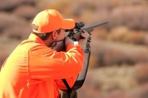 Man using hunting optics to spot a kill
