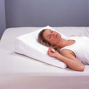 Woman sleeping on a memory foam wedge pillow