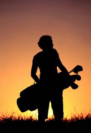 Silhouette of woman with golf bag 