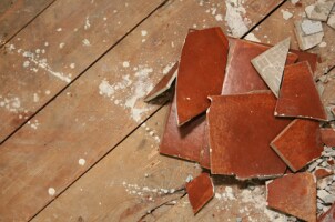 Wood subfloor and broken tiles