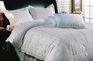 Bed with white down comforter