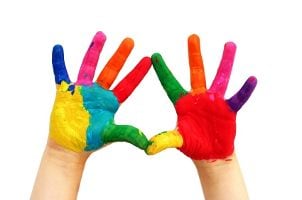 Kid's hands covered in finger paint