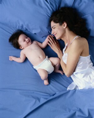 Mother in bed with her baby
