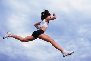 Althletic woman running in fitness clothing