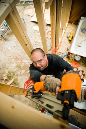 Man using an air nailer