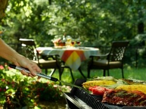 Cooking vegetables and meat on a BBQ grill