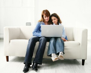 Mother and daughter using laptop computer