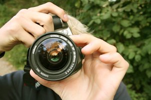 Man taking a picture with a digital SLR camera