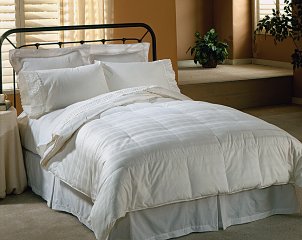 Queen size bed made with white down bedding