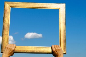 Holding a picture frame to the sky