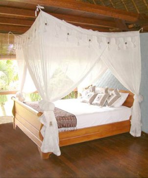 Queen bed with a white canopy