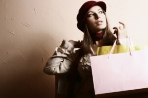 Beautiful woman carrying shopping bags full of clothes