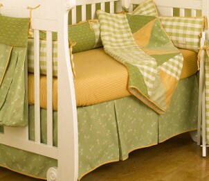 Baby mattress in a yellow and green convertible crib