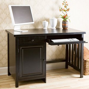 Dark wood computer desk in a home office