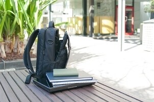 Student's laptop backpack lying open on a table