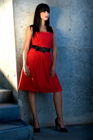 Woman wearing a red strapless dress with a belt