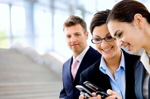 Business associates using a cell phone