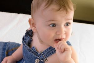 Cute baby boy wearing denim overalls