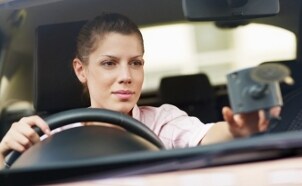 Woman using a GPS in her car