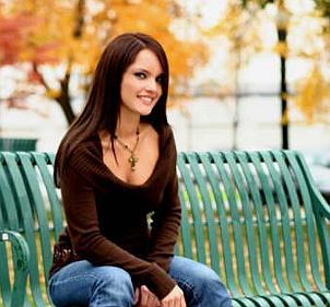 Beautiful brunette woman uses an ionic hair dryer