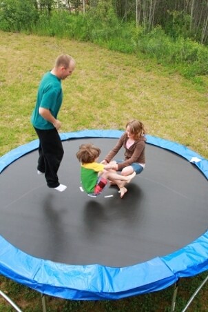 Family jumping on a trampoline