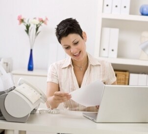 Woman reviewing documents from an inkjet printer