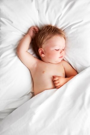 Sleeping baby watched by mom on a video baby monitor