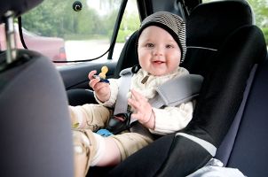 Smiling baby in a car seat