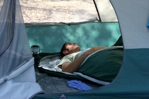 Camper sleeping in a sleeping bag