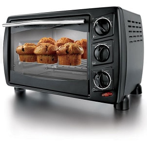 Black toaster oven with muffins baking inside