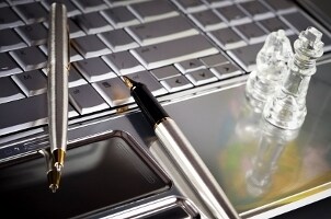 Silver pens lying on a keyboard