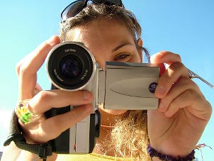 Woman filming with a video camera