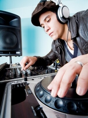 Man wearing headphones and using DJ equipment