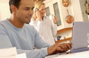 Man typing on a grey laptop