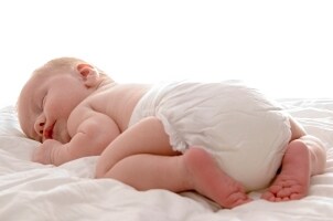 Cute baby sleeping in a diaper