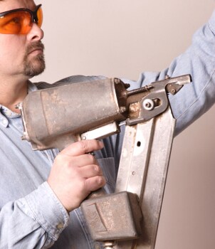 Man holding a nail gun air tool