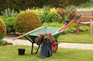 Wheelbarrow and other landscape supplies in the yard