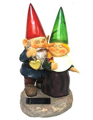 Two snuggling garden gnomes used as a path light