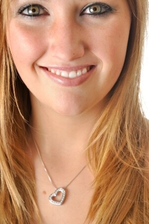 A pretty girl wearing a diamond heart pendant