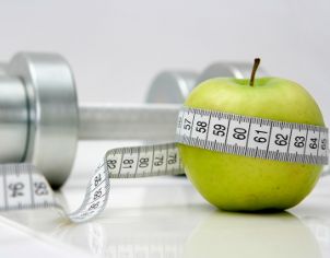 Steel barbell and a golden apple