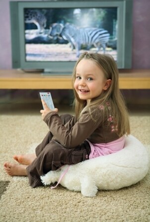 Little girl watching a cheap LCD TV
