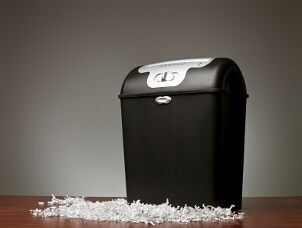 A black paper shredder on a desk