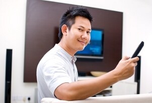 Man watching a Blu-ray movie on his home theater system