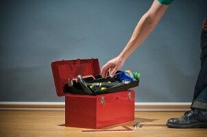 College student reaching into a tool set