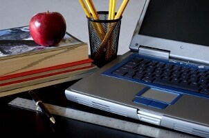 Laptop on a computer desk in a dorm