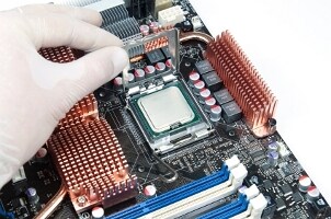 Technician installing a processor into a motherboard