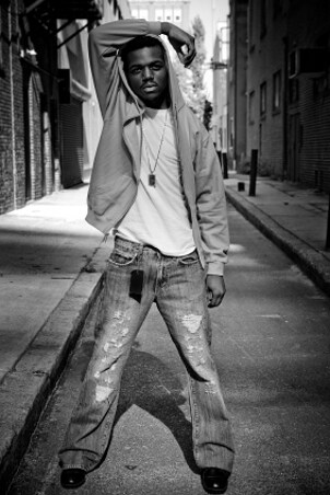 Black and white photo of a man wearing jeans, a T-shirt and cool men's jewelry