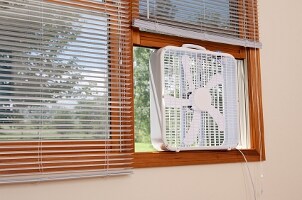 Window fan mounted in wood trim window
