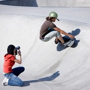 Female photographer taking photos of a skateboarder