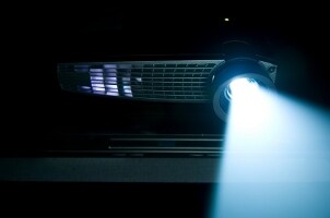 Projector shining light in a dark room